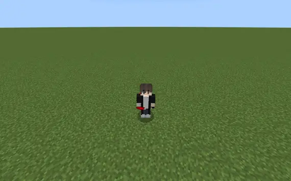 Character holding a red item on grass field