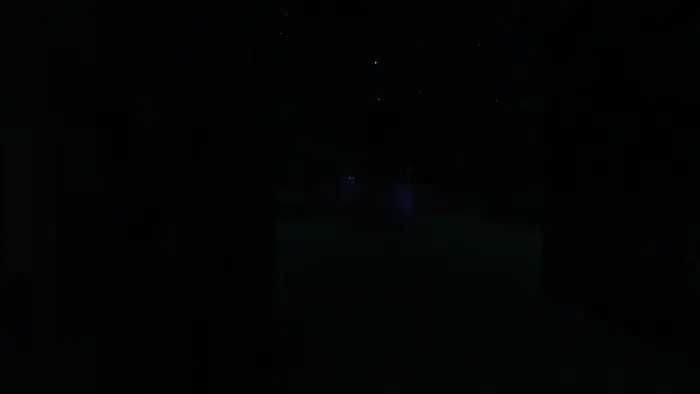 Glowing eyes of Goatman Brother in darkness