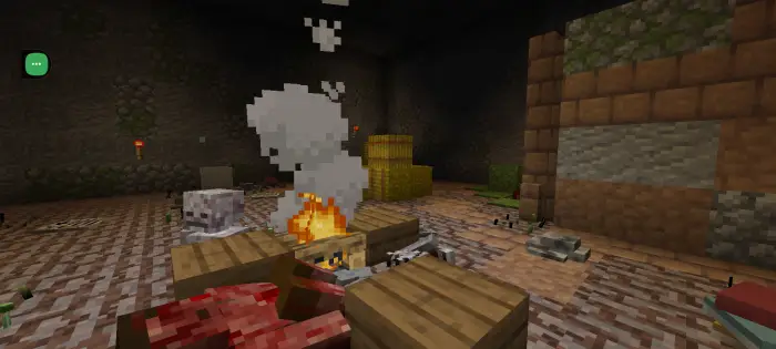 Campfire scene in a dark, bloody cavern