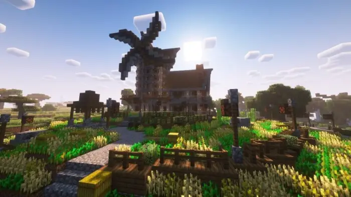 Windmill and farmhouse in a sunny field