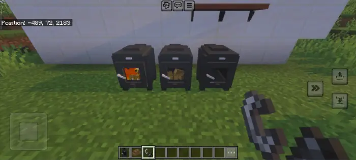 Three black stoves with items inside.