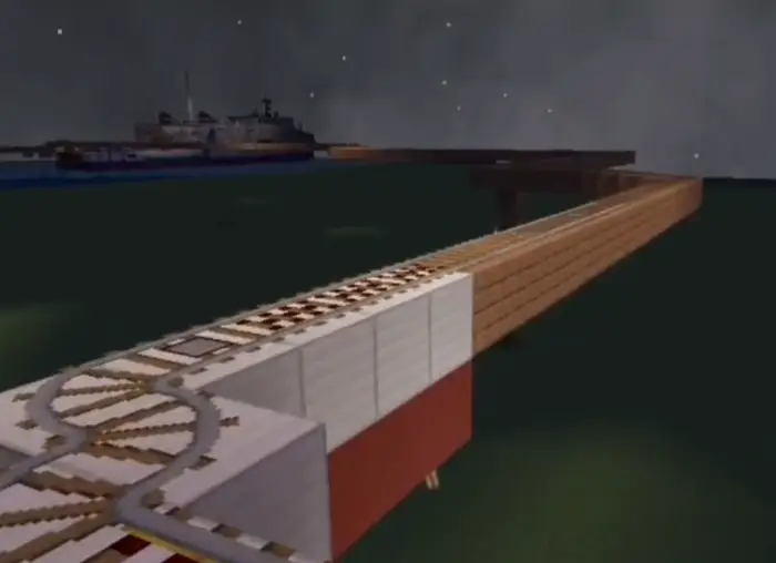 Rail track bridge leading toward a distant ship