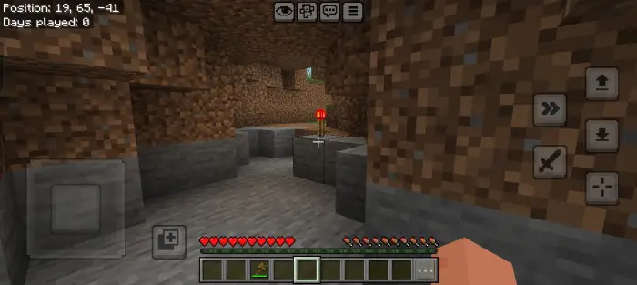 ALT text Empty cave with a single red torch.