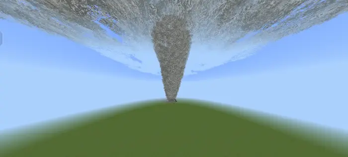 Large tornado funnel over grassy terrain