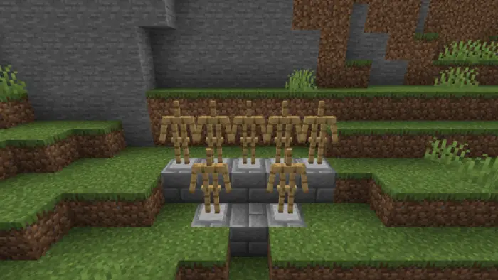 Six empty armor stands on stone steps