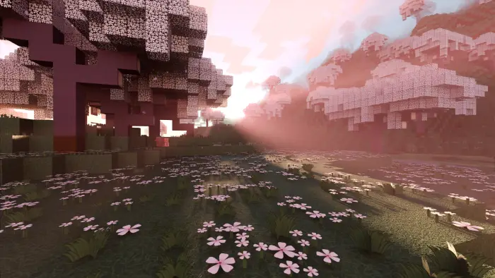 Pink trees and flowers in a sunlit meadow