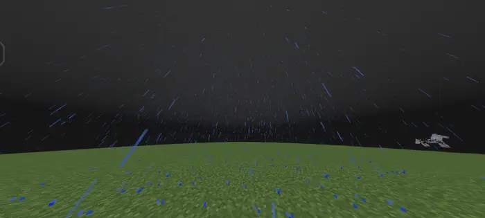 Heavy rain falling on grassy landscape