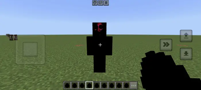 Shadowy figure with a red face on grass