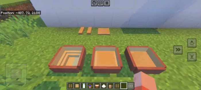 Three decorative bowls on grass in-game