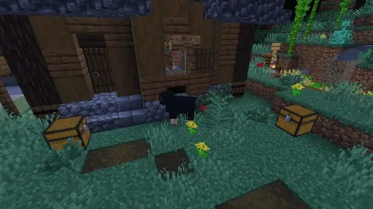 Two chests by a house with flowers at night