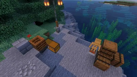 Barrels, chests, and lanterns on a shoreline