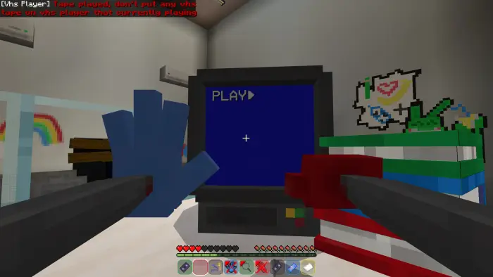 VHS player screen with blue and red hands
