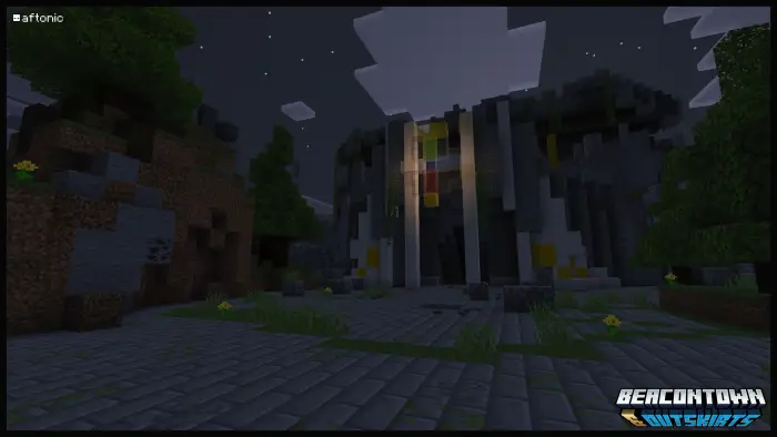 Stone building at night with trees and path