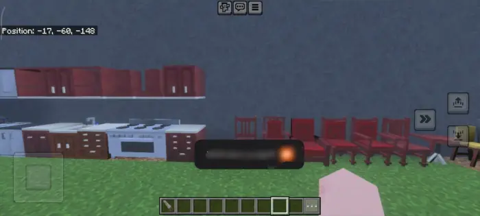 Kitchen cabinets and red chairs in-game.