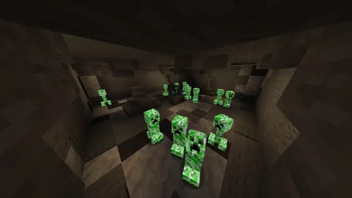Glowing green mobs in a dark cave