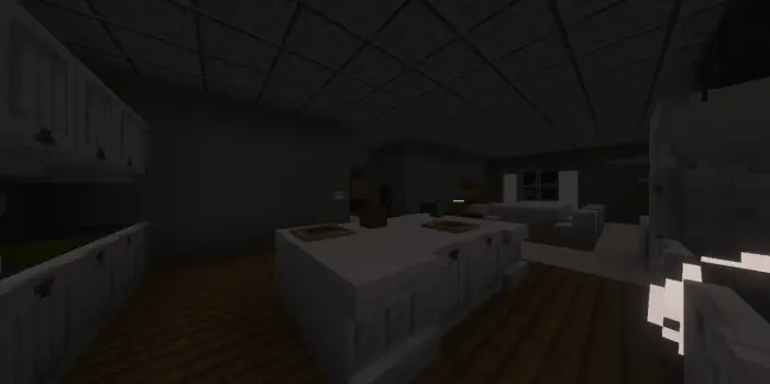 Dimly lit blocky kitchen and living area