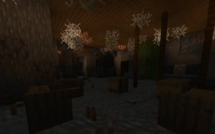 Dimly lit room with crates and cobwebs