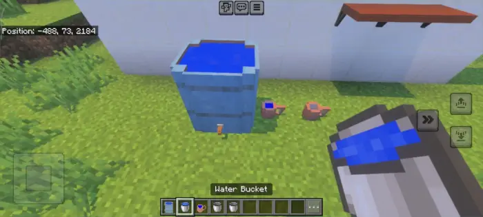 Blue water barrel and small jugs on grass