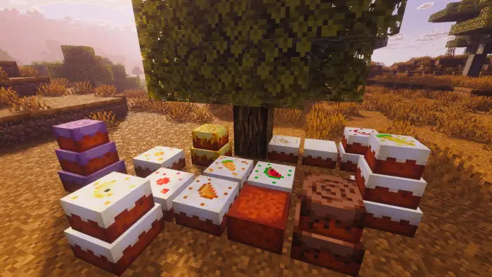 Various colorful cakes placed under a tree