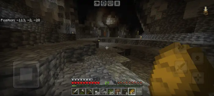 Exploring a dark, torch-lit cave corridor