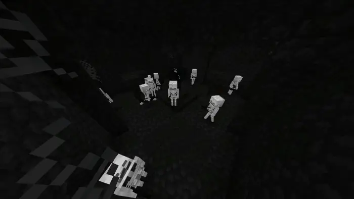 Glowing skeleton mobs stand out in darkness.