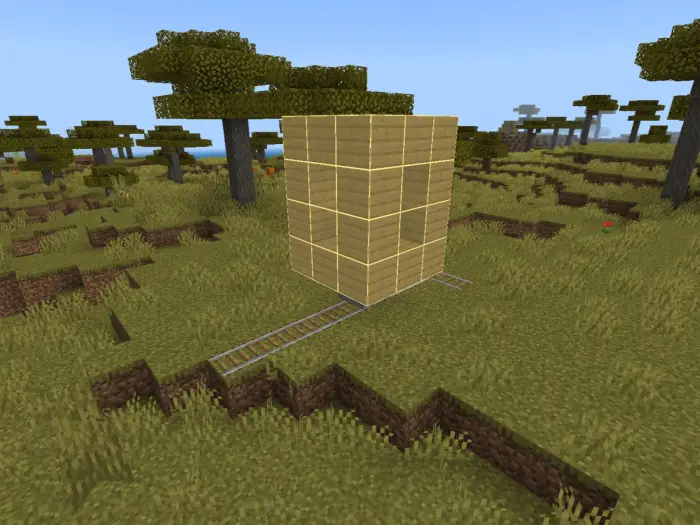 Blocky custom train on rails in savanna biome