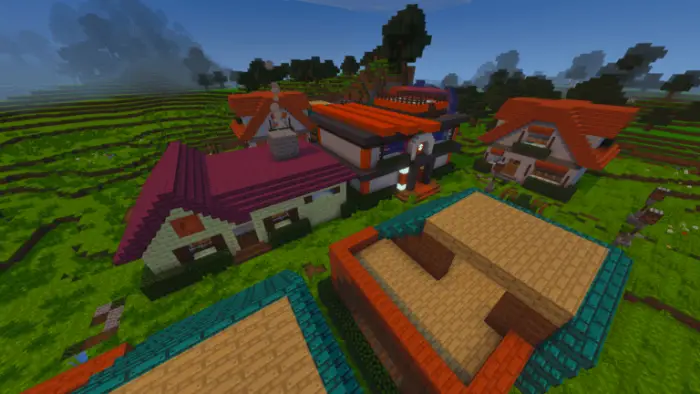 Colorful village buildings in a grassy landscape