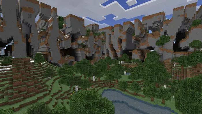 Blocky cliffs and forested valley by a pond