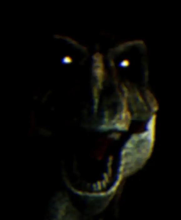 Glowing-eyed dinosaur snarling in darkness