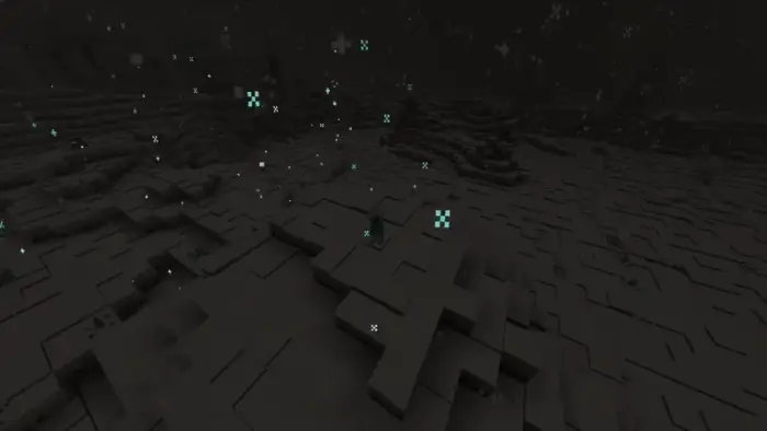 Colored particles glowing in a dark terrain