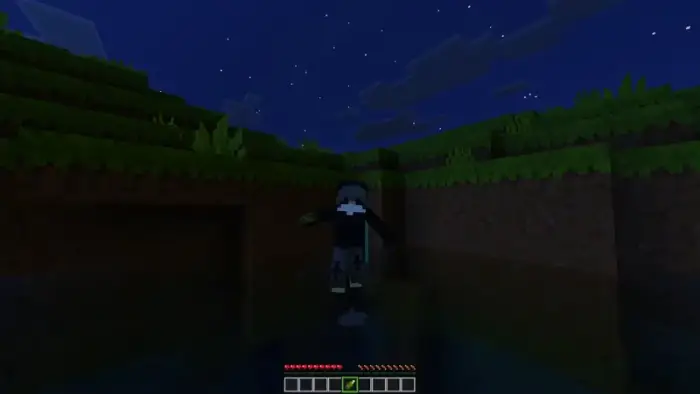 Player holds glowing item at night outdoors