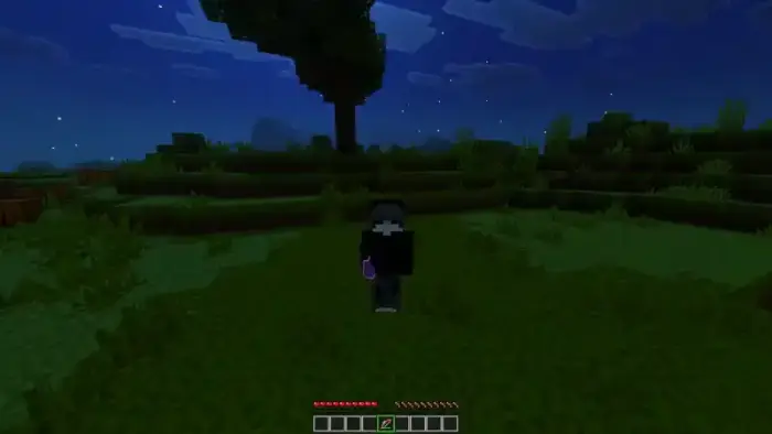 Player holding glowing item at night