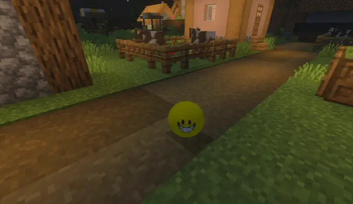 Yellow smiling orb on village path at night