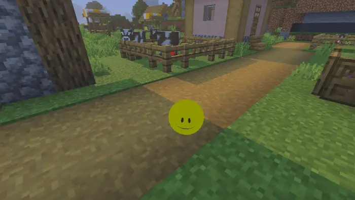 Yellow smiling orb floats on village path
