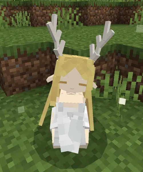 Companion with antlers sitting on grass