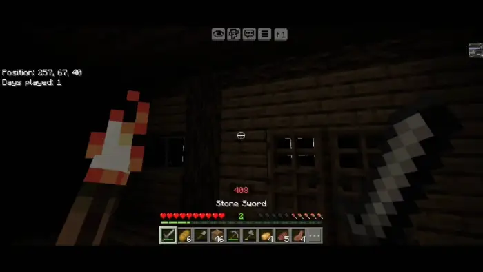 Player holding torch and sword inside a cabin