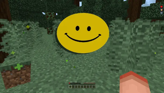 Large yellow smiley face emoji in forest