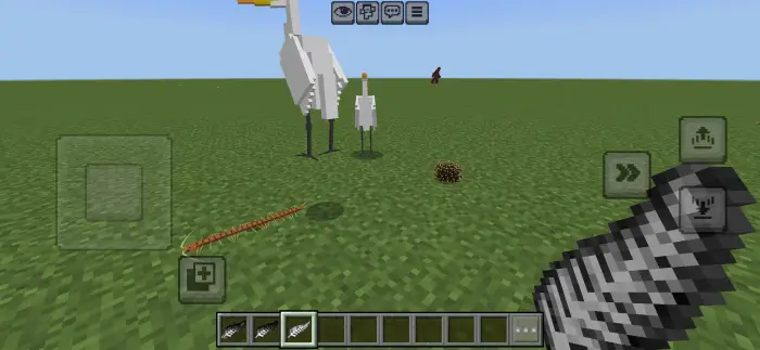Blocky birds and creatures on grassy terrain