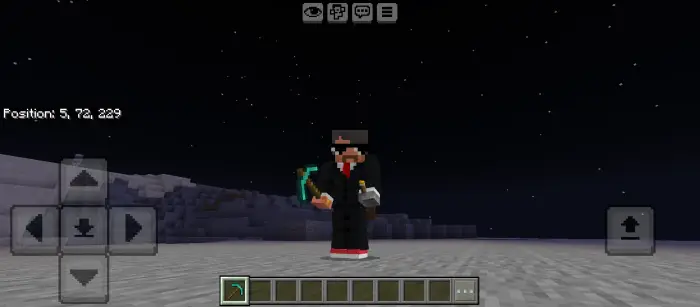 Player holds torch and tool under starry sky