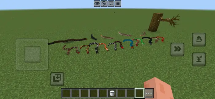 ALT Colorful snakes lined up on grassy terrain