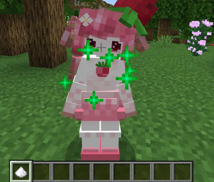 Pink companion character with green sparkles.
