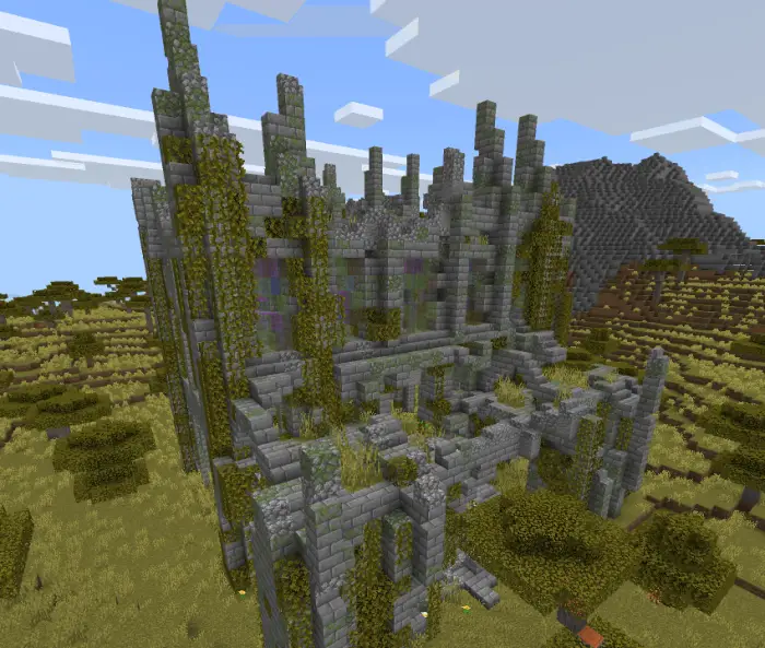 Overgrown stone ruins in grassy landscape