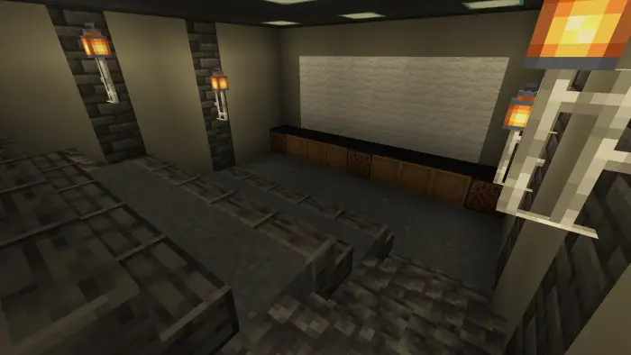 Home theater room with tiered stone seating