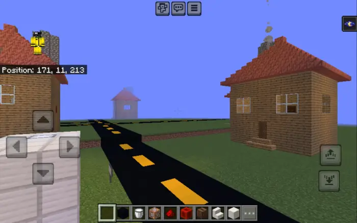 Two blocky houses by a road under blue sky