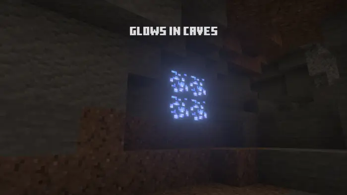 Glowing ore blocks illuminate a dark cave.