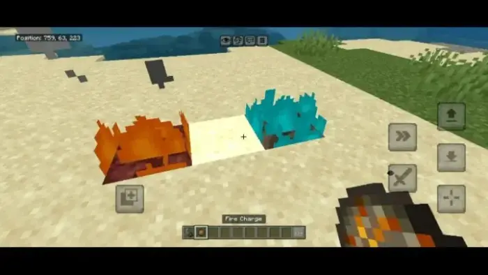 Orange and blue fire on sandy terrain