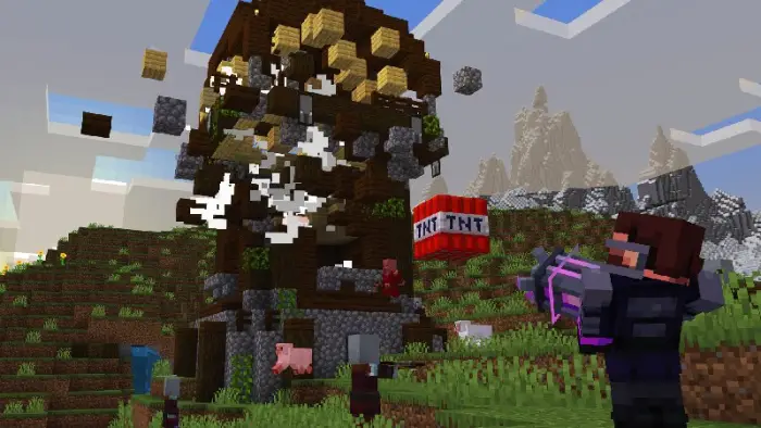 Blocks explode as TNT detonates a wooden tower.