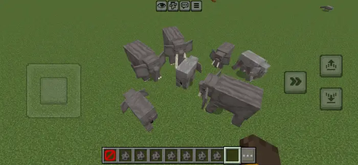 Blocky gray elephants grouped on grass