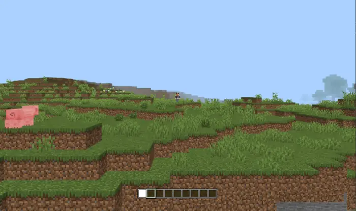 Side-scrolling grassy terrain with a pig