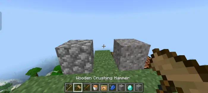 Player holding wooden hammer near stone blocks